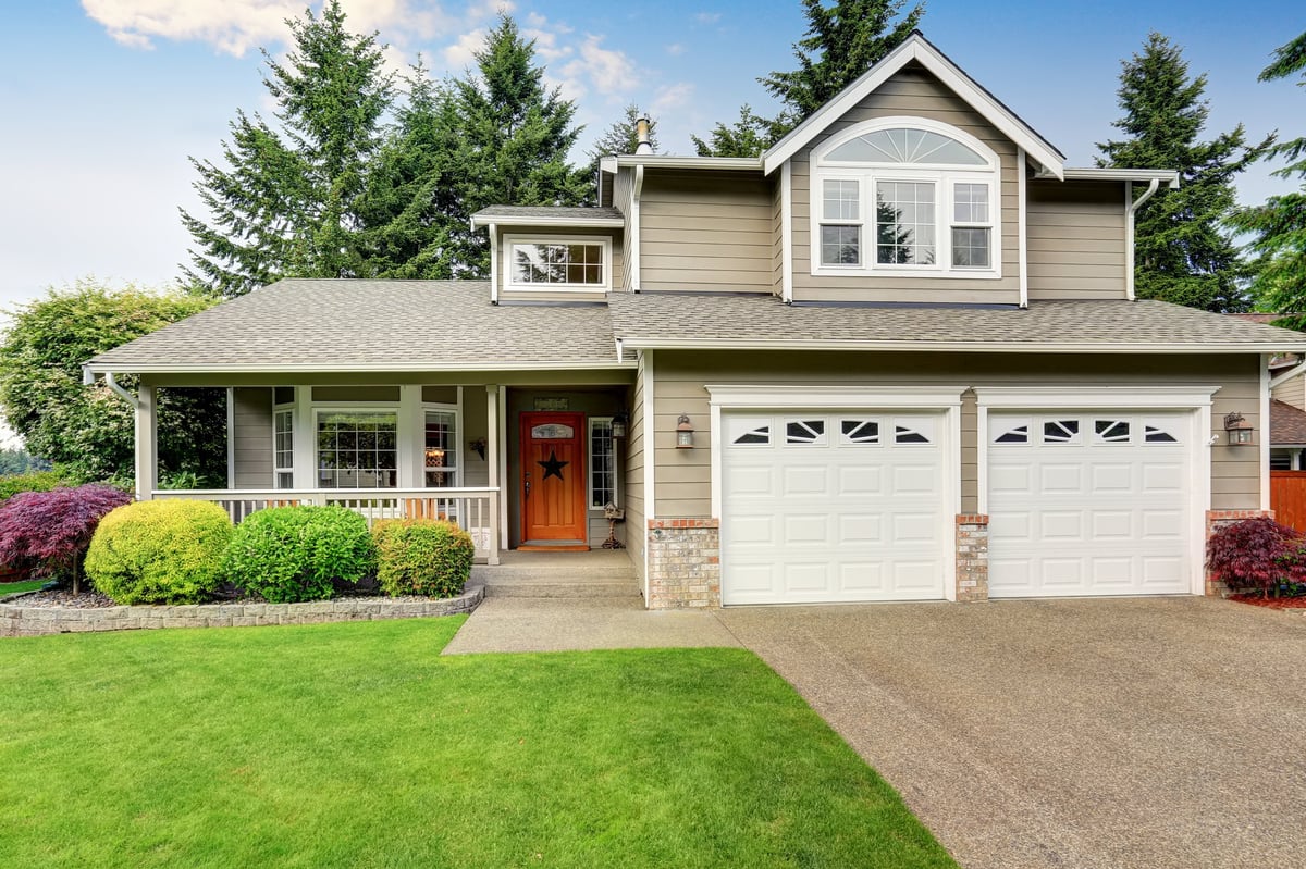American house exterior with double garage and well kept lawn